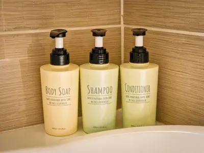 a group of three shampoo bottles sitting on a sink at Villa Green garden in Ayia Napa