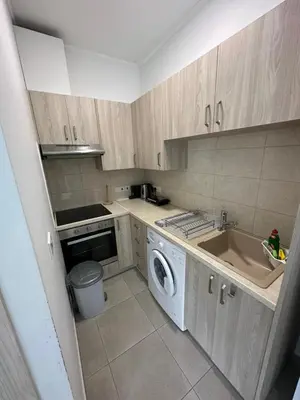 a kitchen with a washing machine and a sink at Modern city center studio saripolou in Limassol