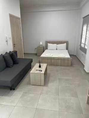 a living room with a bed and a couch at Modern city center studio saripolou in Limassol