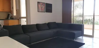 a living room with a blue couch in a room at ELLA LUXURY APARTMENT - (BREAKBOOKING CY) in Limassol