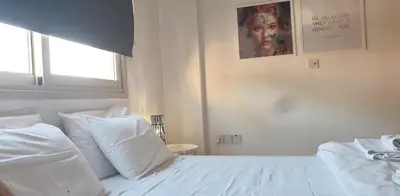 a white bed with white pillows in a bedroom at ELLA LUXURY APARTMENT - (BREAKBOOKING CY) in Limassol