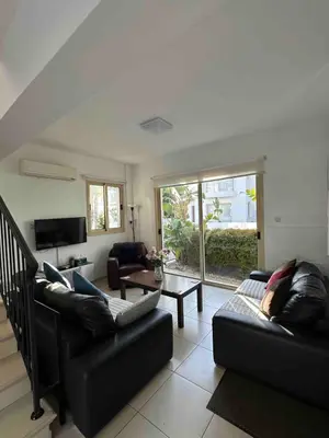 a living room with two couches and a table at LC Palm Villa in Protaras