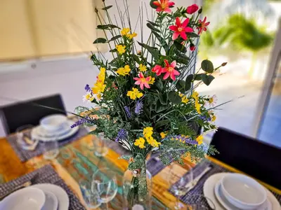 a vase filled with flowers sitting on a table at Nissi beach villa Oleandra in Ayia Napa
