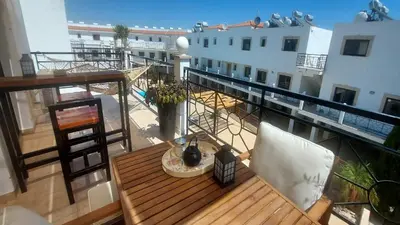 a balcony with a table and chairs on a building at Paramount Gardens Resorts C201 in Larnaka