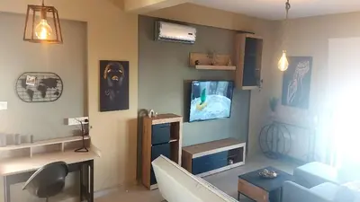 a living room with a tv on a wall at Paramount Gardens Resorts C201 in Larnaka