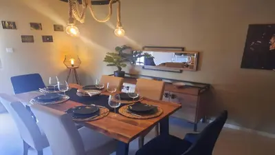 a dining room table with wine glasses on it at Paramount Gardens Resorts C201 in Larnaka