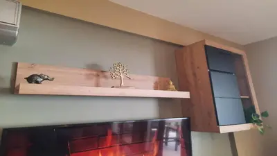 a wooden shelf on a wall with a tv at Paramount Gardens Resorts C201 in Larnaka