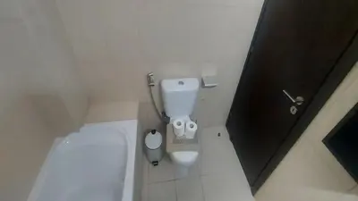 a small bathroom with a toilet in a stall at Paramount Gardens Resorts C201 in Larnaka