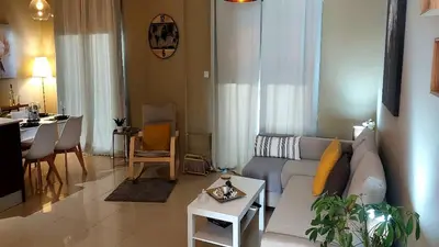 a living room with a couch and a table at Paramount Gardens Resorts C202 in Larnaka