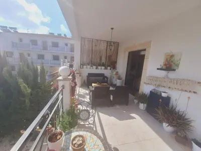 a balcony with a table and chairs and a building at Paramount Gardens Resorts C202 in Larnaka