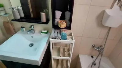 a bathroom with a white sink and a mirror at Paramount Gardens Resorts C202 in Larnaka