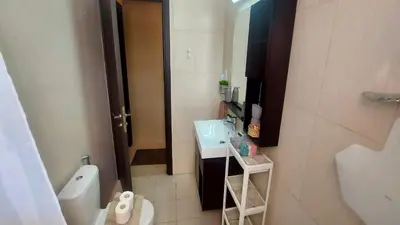 a small bathroom with a sink and a toilet at Paramount Gardens Resorts C202 in Larnaka