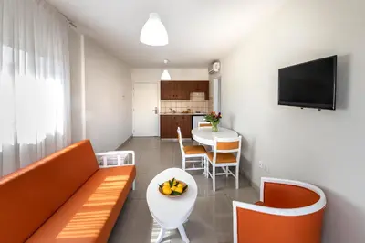 a living room with a couch and a table at Mia Hotel Apartment in Ayia Napa