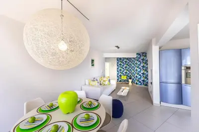 a living room with a table with plates on it at Protaras Pallini 201 Seaside Suite in Protaras