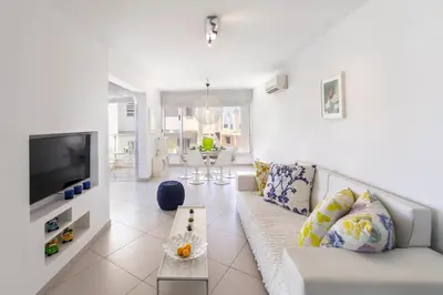 a living room with a couch and a tv at Protaras Pallini 201 Seaside Suite in Protaras