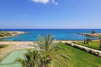 an aerial view of a tennis court and the ocean at VERONICA - Coralli Beachfront Apartment in Protaras