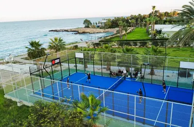an overhead view of a tennis court next to the ocean at VERONICA - Coralli Beachfront Apartment in Protaras