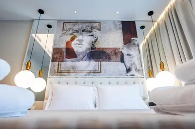 a bedroom with a bed with a painting on the wall at Gate Twenty Two Boutique Hotel in Nicosia
