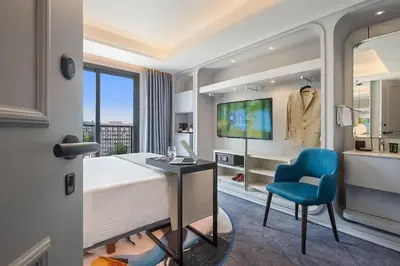 a bedroom with a bed and a desk and a chair at Gate Twenty Two Boutique Hotel in Nicosia