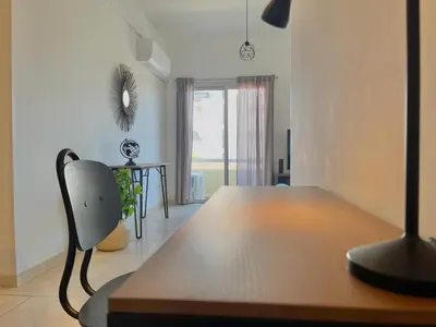 a bedroom with a desk and a chair in a room at Urban Retreat - Your Ideal Getaway in Limassol in Limassol