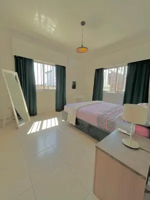 a bedroom with a bed and a table with a lamp at Urban Retreat - Your Ideal Getaway in Limassol in Limassol