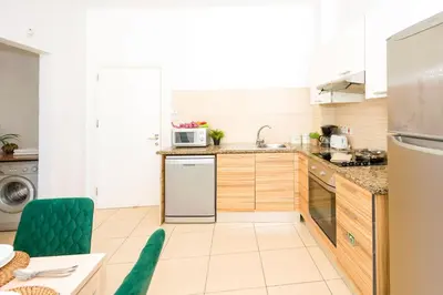 a kitchen with a sink and a refrigerator at ALICIA - Coralli Beachfront Apartment in Paralimni
