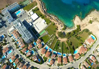 an aerial view of a city next to the ocean at DIANA - Coralli Beachfront Apartment in Protaras