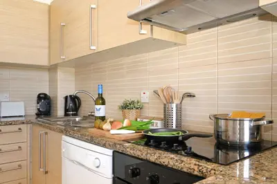 a kitchen with a counter top with a pot on a stove at MERYL - Coralli Beachfront Apartment in Protaras