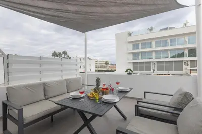 a living room with a couch and a table on a balcony at Evas Apartment in Protaras