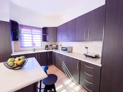 a kitchen with a bowl of fruit on a counter at FAME villa with Private Pool and Gazebo in Ayia Napa