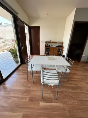 a dining room with a white table and chairs at Extremely comfy apt with spacious private terrace 10min walk to the beach & in Town in Larnaka