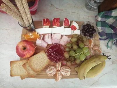a cutting board with different types of food on it at Extremely comfy apt with spacious private terrace 10min walk to the beach & in Town in Larnaka