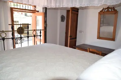 a bedroom with a bed and a window and a mirror at Konatzin tou Massou by Raise in Moutoullas