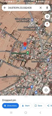 a map of a city with two red dots at Vasilis house in Mor Menekshe
