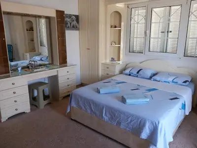 a bedroom with a bed and a sink and a mirror at Vasilis house in Mor Menekshe