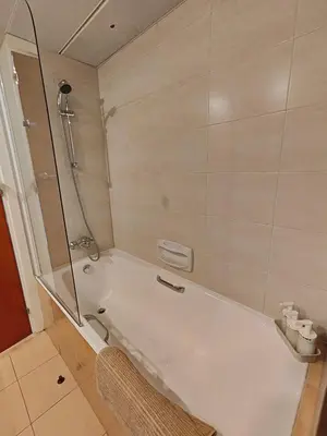 a bathroom with a shower and a white tub at Ευ ζην Central / Ev zen central in Nicosia