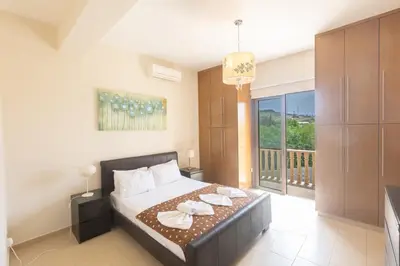 a bedroom with a bed with two plates on it at Sparta Luxury Villa in Protaras