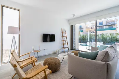 a living room with a couch and chairs and a tv at Waves 3-Bedroom Villa in Protaras in Paralimni