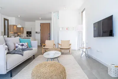 a living room with a couch and a table at Waves 3-Bedroom Villa in Protaras in Paralimni