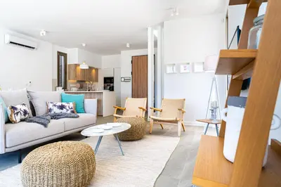a living room with a couch and a table at Waves 3-Bedroom Villa in Protaras in Paralimni
