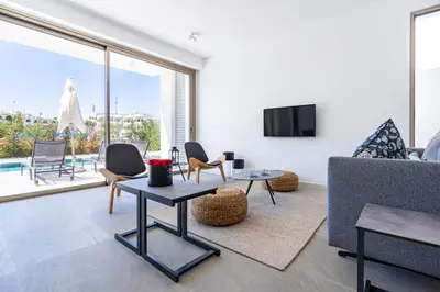 a living room with a couch and a tv at Cyan 3-Bedroom Villa in Protaras in Paralimni