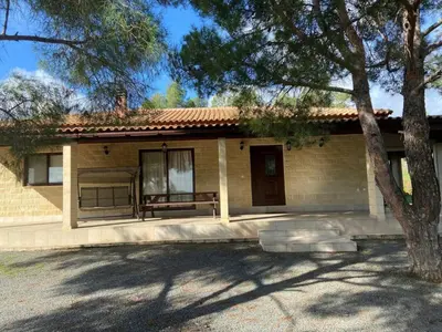 a small house with a bench in front of it at Stavros Country House in Siá