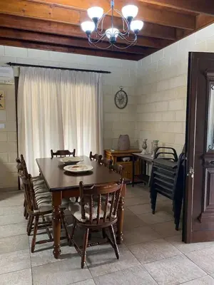 a dining room with a wooden table and chairs at Stavros Country House in Siá