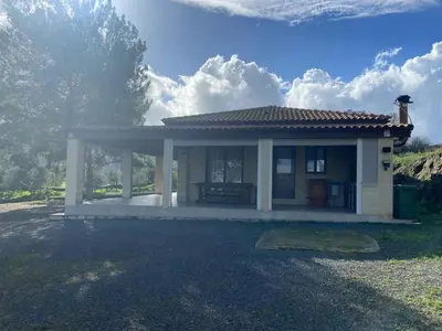 a small house with a roof on a field at Stavros Country House in Siá