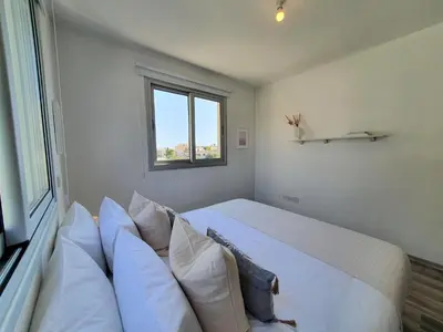 a bedroom with a large bed and a window at Phaedrus Living: City Center Cozy Flat Demetra 102 in Larnaka