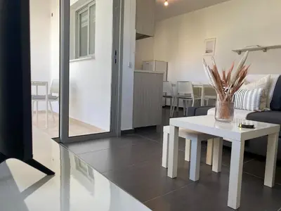 a living room with a table and a couch at Phaedrus Living: City Center Cozy Flat Demetra 102 in Larnaka