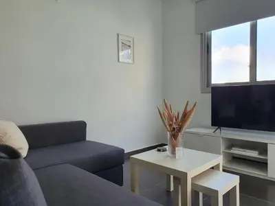 a living room with a couch and a tv at Phaedrus Living: City Center Cozy Flat Demetra 102 in Larnaka