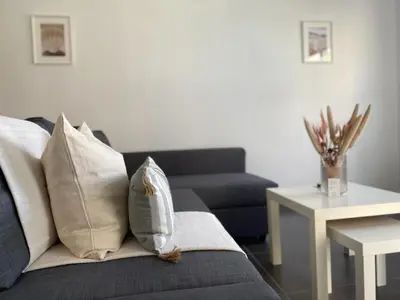a living room with a couch with pillows and a table at Phaedrus Living: City Center Cozy Flat Demetra 102 in Larnaka