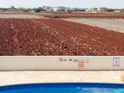 two pictures of a farm with a dirt field at Liopetri 2-Bed Apt Sleeps 6 Pool 10min to Beach in Liopetri