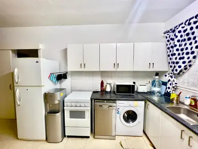 a kitchen with a white refrigerator and a dishwasher at TaniAndres apartments in Paralimni